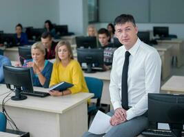 students with teacher  in computer lab classrom photo