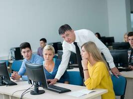 students with teacher  in computer lab classrom photo