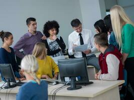 students with teacher  in computer lab classrom photo