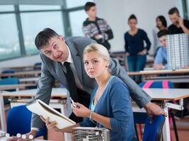 students with teacher  in computer lab classrom photo