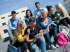 students outside sitting on steps photo