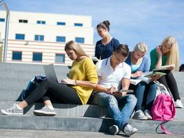 students outside sitting on steps photo