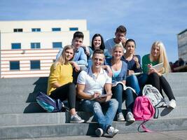 students outside sitting on steps photo