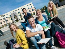 students outside sitting on steps photo