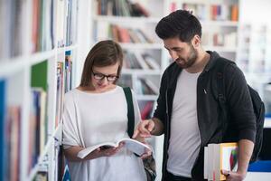 students couple  in school  library photo