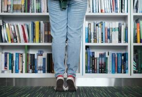 famale student selecting book to read in library photo
