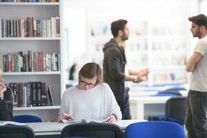 female student study in school library, group of students in background photo