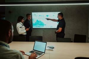 Group of Security data center operators working in a CCTV monitoring room looking on multiple monitors Officers Monitoring Multiple Screens for Suspicious Activities Team working on the System Contr photo