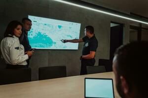 Group of Security data center operators working in a CCTV monitoring room looking on multiple monitors Officers Monitoring Multiple Screens for Suspicious Activities Team working on the System Contr photo