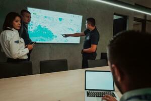 Group of Security data center operators working in a CCTV monitoring room looking on multiple monitors Officers Monitoring Multiple Screens for Suspicious Activities Team working on the System Contr photo