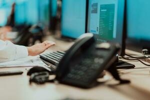Female security operator working in a data system control room offices Technical Operator Working at workstation with multiple displays, security guard working on multiple monitors photo
