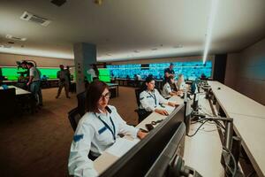 Group of female security operators working in a data system control room Technical Operators Working at workstation with multiple displays, security guards working on multiple monitors in surveillan photo