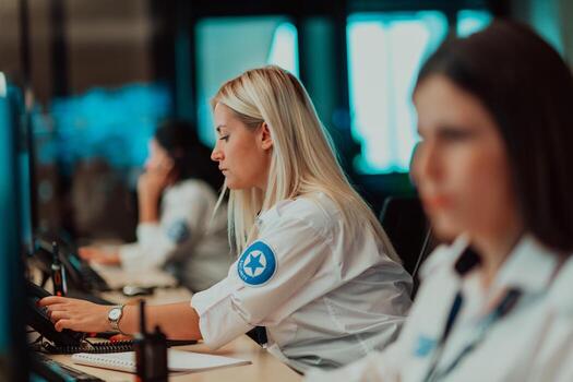 Female security operator working in a data system control room offices Technical Operator Working at workstation with multiple displays, security guard working on multiple monitors photo
