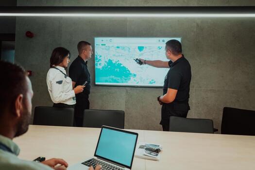 Group of Security data center operators working in a CCTV monitoring room looking on multiple monitors Officers Monitoring Multiple Screens for Suspicious Activities Team working on the System Contr photo