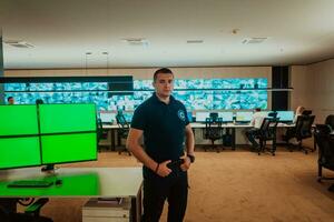 Male security operator working in a data system control room offices Technical Operator Working at workstation with multiple displays, security guard working on multiple monitors Male computer opera photo