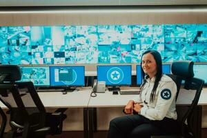 Female security operator working in a data system control room offices Technical Operator Working at workstation with multiple displays, security guard working on multiple monitors photo