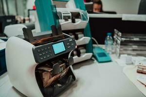 Sorted banknotes placed on the table after it is counted on the electronic money counting machine photo