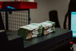 Sorted banknotes placed on the table after it is counted on the electronic money counting machine photo