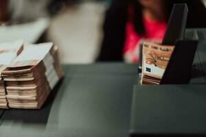 Sorted banknotes placed on the table after it is counted on the electronic money counting machine photo