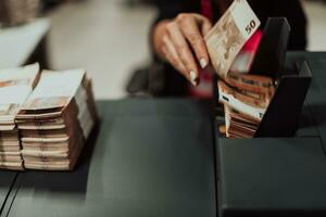 Sorted banknotes placed on the table after it is counted on the electronic money counting machine photo