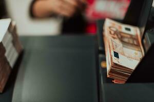 ordenado billetes metido en el mesa después eso es contado en el electrónico dinero contando máquina foto