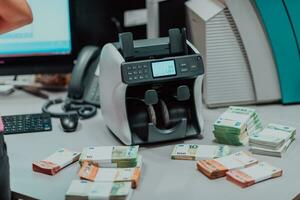 Sorted banknotes placed on the table after it is counted on the electronic money counting machine photo