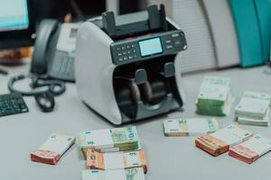 Sorted banknotes placed on the table after it is counted on the electronic money counting machine photo