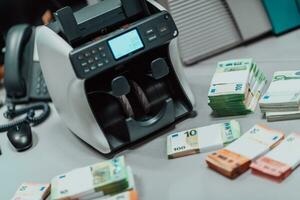 Sorted banknotes placed on the table after it is counted on the electronic money counting machine photo