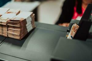 Sorted banknotes placed on the table after it is counted on the electronic money counting machine photo