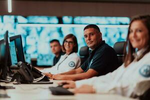 Group of Security data center operators working in a CCTV monitoring room looking on multiple monitors Officers Monitoring Multiple Screens for Suspicious Activities Team working on the System Contr photo