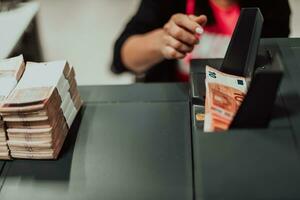 ordenado billetes metido en el mesa después eso es contado en el electrónico dinero contando máquina foto