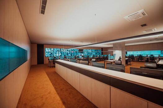 Empty interior of big modern security system control room, workstation with multiple displays, monitoring room with at security data center Empty office, desk, and chairs at a main CCTV security data photo