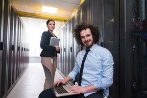 Team of young technicians working together on servers photo