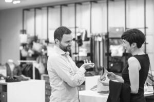 couple chooses shoes At Shoe Store photo