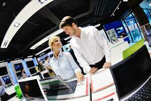 Young couple in consumer electronics store photo