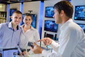 people buy  in consumer electronics store photo