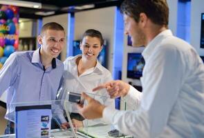 people buy  in consumer electronics store photo