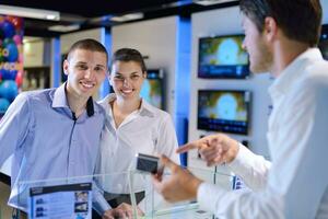 Young couple in consumer electronics store photo