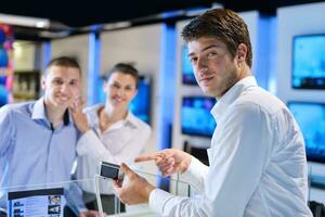 Young couple in consumer electronics store photo