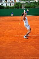 Man plays tennis outdoors photo