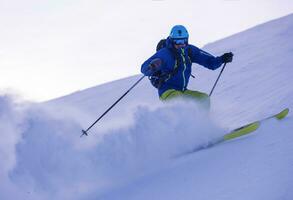 Skier having fun while running downhill photo