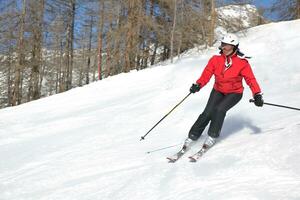 skiing on fresh snow at winter season at beautiful sunny day photo