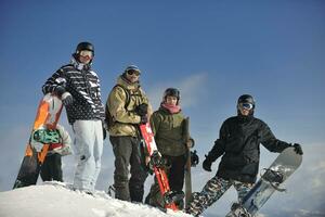 snowboarders group relaxing and enjoy sun photo