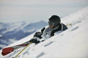 young skier relaxing at beautiful sunny winter day photo