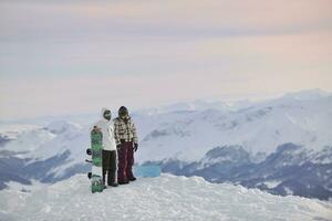 snowboarder's couple on mountain's top photo