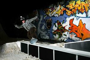 freestyle snowboarder jump in air at night photo