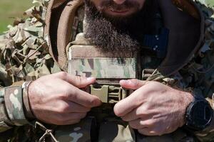 special operations soldiers team preparing tactical and communication gear for action battle. Long distance sniper team in checking gear for action photo