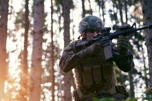 soldier in action aiming  on weapon  laser sight optics photo