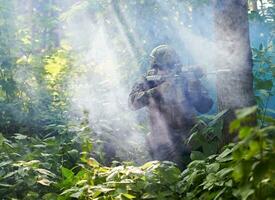 soldier in action aiming  on laser sight optics photo