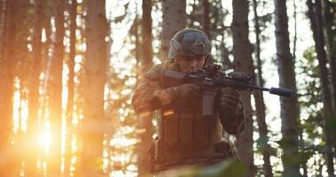 soldier in action aiming  on weapon  laser sight optics photo